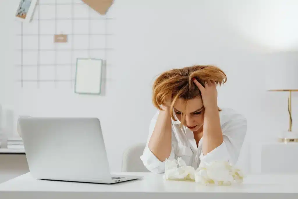 Office workspace with scattered scripts and papers, depicting creative frustration in TV production