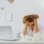 Office workspace with scattered scripts and papers, depicting creative frustration in TV production
