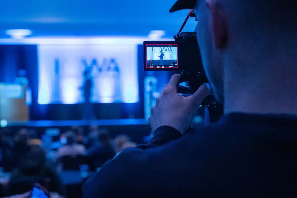 A game director presenting at a gaming conference, speaking about an upcoming RPG project