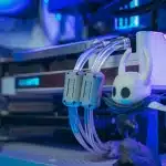 Gamer's hands on controller with fantasy game modding interface on screen