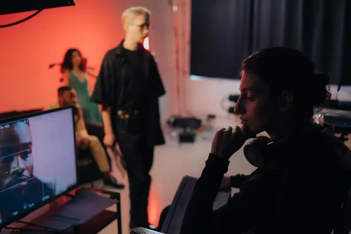 Actress collaborating with director and crew members on a dramatic production set