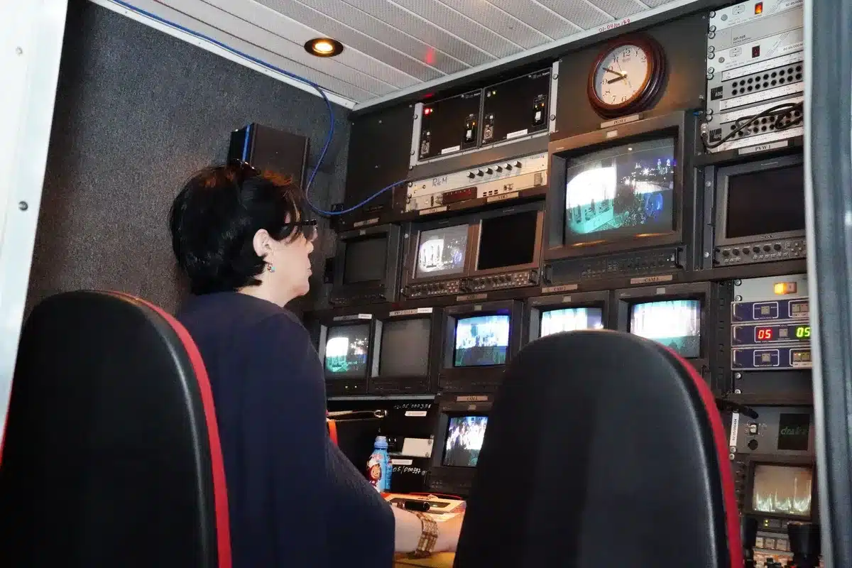 A professional television production set with lighting and camera equipment in an HBO-style environment.