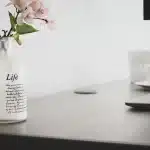 Anonymous ballots and envelopes on a rehearsal table with coffee cup and remote