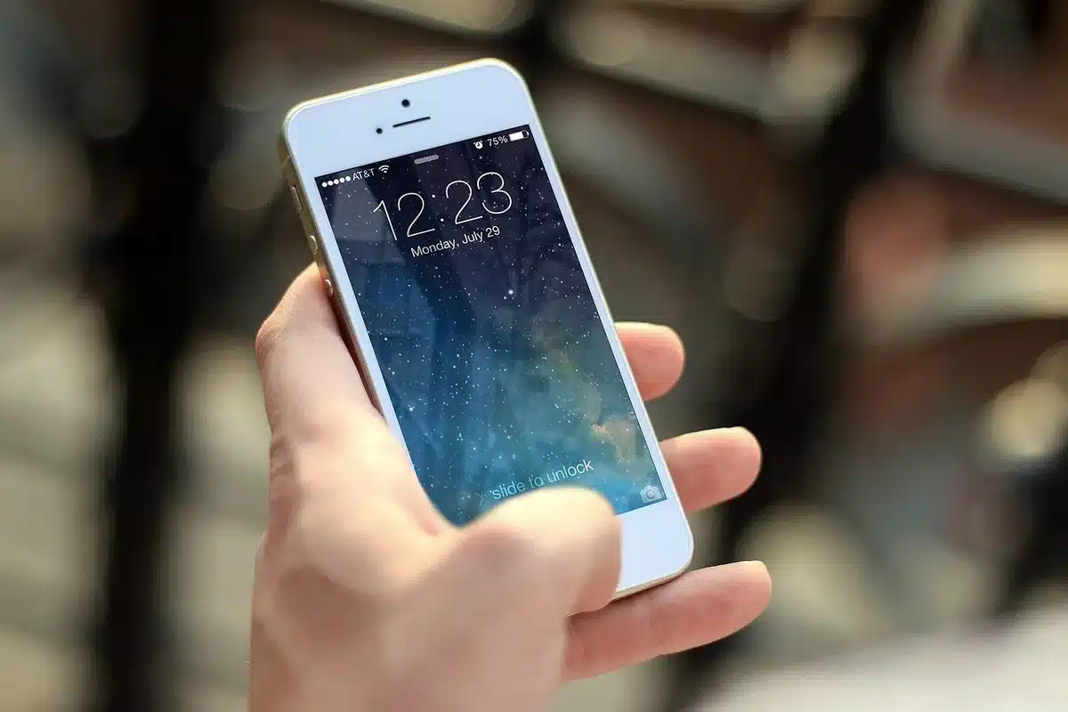 Smartphone showing a sleep app next to a sleeping child's toy
