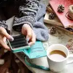 Smartphone and sleep-tracking wristband on a bedside table at dawn