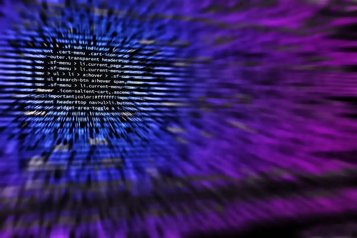 Close-up of a computer screen showing code and app launcher interface