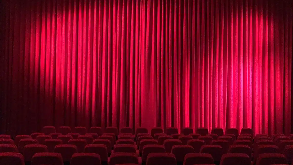 Small audience watching an independent film in a cozy screening room